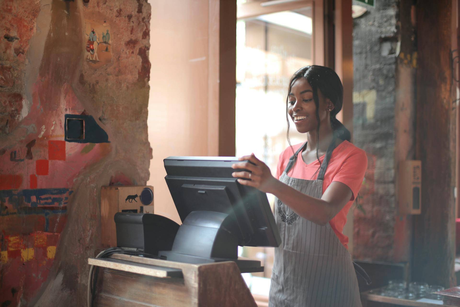 Restaurant staff using t’order on a table-mounted tablet, syncing with Clover PO